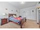 Cozy bedroom featuring a wooden bed frame and light-colored carpeting at 312 Amble Side, Mcdonough, GA 30252