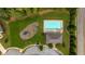 Aerial view showcasing community pool and playground surrounded by green space, benches and mature trees at 312 Amble Side, Mcdonough, GA 30252