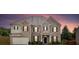 Charming two-story brick home featuring a two-car garage and well-manicured landscaping at 312 Amble Side, Mcdonough, GA 30252