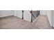 Carpeted hallway with dark wood banister and white doors at 312 Amble Side, Mcdonough, GA 30252
