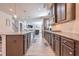 Open concept kitchen with stainless appliances, granite counters, and ample storage and modern lighting at 312 Amble Side, Mcdonough, GA 30252