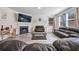Spacious living room featuring dark leather seating, fireplace, and wood-look floors at 312 Amble Side, Mcdonough, GA 30252