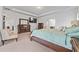 This bright main bedroom includes a king bed, an ensuite bath, and a television at 312 Amble Side, Mcdonough, GA 30252