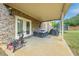 Covered patio with outdoor furniture and a view of the spacious backyard at 312 Amble Side, Mcdonough, GA 30252