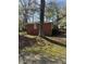 Cozy brick home backyard with mature tree, shrubbery, and healthy green lawn at 3674 Canton Rd, Marietta, GA 30066