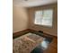 Bedroom with hardwood floors, neutral walls, and a window for natural light at 3674 Canton Rd, Marietta, GA 30066
