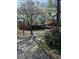 A single-Gathering home set amongst beautiful trees and landscaping, with a cracked driveway at 3674 Canton Rd, Marietta, GA 30066