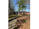 Exterior shot of a brick home with a paved walkway and well-kept lawn with trees at 3674 Canton Rd, Marietta, GA 30066