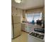 The kitchen features white appliances, cabinets, and a window above the sink at 3674 Canton Rd, Marietta, GA 30066