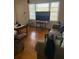 Warm living area featuring hardwood flooring, a large window, and ample space for furniture at 3674 Canton Rd, Marietta, GA 30066