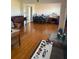 Open living area with wood floors, a piano, and a view into the dining area at 3674 Canton Rd, Marietta, GA 30066