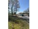 Street view with blue truck driving on the road and green space on the shoulder at 3674 Canton Rd, Marietta, GA 30066