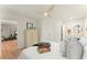 Bright bedroom features a ceiling fan, light wood floors, and doorway leading into the living space at 1990 Venetian Sw Dr, Atlanta, GA 30311