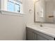 Modern half bathroom features a quartz countertop and updated fixtures at 6812 Cadence Blvd, Atlanta, GA 30328