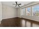 Bright bedroom with large windows, ceiling fan, and hardwood floors at 6812 Cadence Blvd, Atlanta, GA 30328