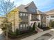 Beautiful townhome featuring a brick facade, manicured landscaping, and welcoming entryway at 6812 Cadence Blvd, Atlanta, GA 30328