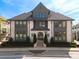 Elegant brick townhome showcasing symmetrical design, arched entry, and manicured landscaping at 6812 Cadence Blvd, Atlanta, GA 30328