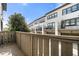 View of townhomes with balconies and attached garages under a partly cloudy sky at 6812 Cadence Blvd, Atlanta, GA 30328