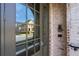 Close-up of front door with brick surround and a view of the street through the glass at 6812 Cadence Blvd, Atlanta, GA 30328