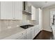 Modern kitchen with white cabinets, subway tile backsplash, and stainless steel appliances at 6812 Cadence Blvd, Atlanta, GA 30328
