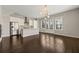 Bright living room featuring hardwood floors, modern lighting, and large windows at 6812 Cadence Blvd, Atlanta, GA 30328