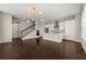 Open concept living space with hardwood floors, modern lighting, and a staircase at 6812 Cadence Blvd, Atlanta, GA 30328
