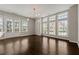 Bright living room featuring hardwood floors, modern lighting, and large windows at 6812 Cadence Blvd, Atlanta, GA 30328