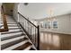 Staircase leading to the living room, featuring hardwood floors and modern lighting at 6812 Cadence Blvd, Atlanta, GA 30328