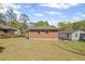 Large backyard showing the brick home and grassy area with a chain link fence at 131 Brownlee Rd, Atlanta, GA 30331