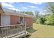 View of the backyard with a brick home, wooden deck, and partial lawn at 131 Brownlee Rd, Atlanta, GA 30331