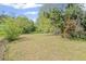 Wide shot of a large grassy backyard with mature trees and shrubbery at 131 Brownlee Rd, Atlanta, GA 30331