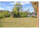 Large, grassy backyard with a partially-fenced perimeter and mature trees at 131 Brownlee Rd, Atlanta, GA 30331