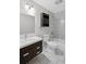 Bathroom with a dark vanity, sink, toilet, tub and shower with white tiled walls and floor at 131 Brownlee Rd, Atlanta, GA 30331