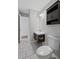 Bathroom with a dark vanity, sink, toilet, tiled floor, and view into an adjacent bedroom at 131 Brownlee Rd, Atlanta, GA 30331