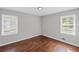 Bedroom features hardwood floors, gray walls, and two windows with blinds at 131 Brownlee Rd, Atlanta, GA 30331