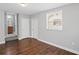 A bedroom has wood floors, grey walls, a window with blinds, and a doorway into a full bathroom at 131 Brownlee Rd, Atlanta, GA 30331