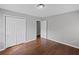Bedroom with hardwood floors, gray walls, closet with double doors, and doorway to another room at 131 Brownlee Rd, Atlanta, GA 30331