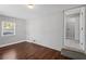 Bedroom with hardwood floors, gray brick wall, a window view to the outside, and access to a laundry room at 131 Brownlee Rd, Atlanta, GA 30331