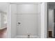 A utility closet with painted walls, tile floor, utility connections, and storage shelf; laundry ready at 131 Brownlee Rd, Atlanta, GA 30331