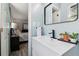 Bright bathroom features a modern vanity with a sleek sink, black faucet, stylish mirror, and tasteful decor at 2491 Falcon Ridge Dr, Grayson, GA 30017