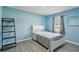 Serene blue bedroom with minimalist decor, tiled floors, and natural light creates a peaceful retreat at 2491 Falcon Ridge Dr, Grayson, GA 30017
