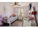Charming bedroom featuring a cozy bed, whimsical decor, and soft, natural light from the window at 2491 Falcon Ridge Dr, Grayson, GA 30017