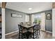 Dining room with hardwood floors, a large window and a modern light fixture at 2491 Falcon Ridge Dr, Grayson, GA 30017