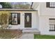 Close-up of the white home's front door with decorative glass and black trim and hardware at 2491 Falcon Ridge Dr, Grayson, GA 30017