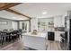 Open concept kitchen with white cabinets, stainless appliances and center island near dining area at 2491 Falcon Ridge Dr, Grayson, GA 30017