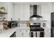 Close up of a kitchen with modern appliances, white countertops and cabinets with black fixtures at 2491 Falcon Ridge Dr, Grayson, GA 30017
