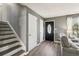 Inviting foyer with wood-look floors, and view of the front door, staircase, and living room at 2491 Falcon Ridge Dr, Grayson, GA 30017