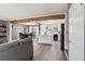 Open-concept living room with wood floors, beam and view of kitchen and dining area at 2491 Falcon Ridge Dr, Grayson, GA 30017
