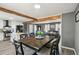 Open concept kitchen, living and dining area with white cabinets, beams and plenty of light at 2491 Falcon Ridge Dr, Grayson, GA 30017