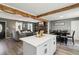 Open concept living room and kitchen, with wood beams, hardwood floors and ample light at 2491 Falcon Ridge Dr, Grayson, GA 30017